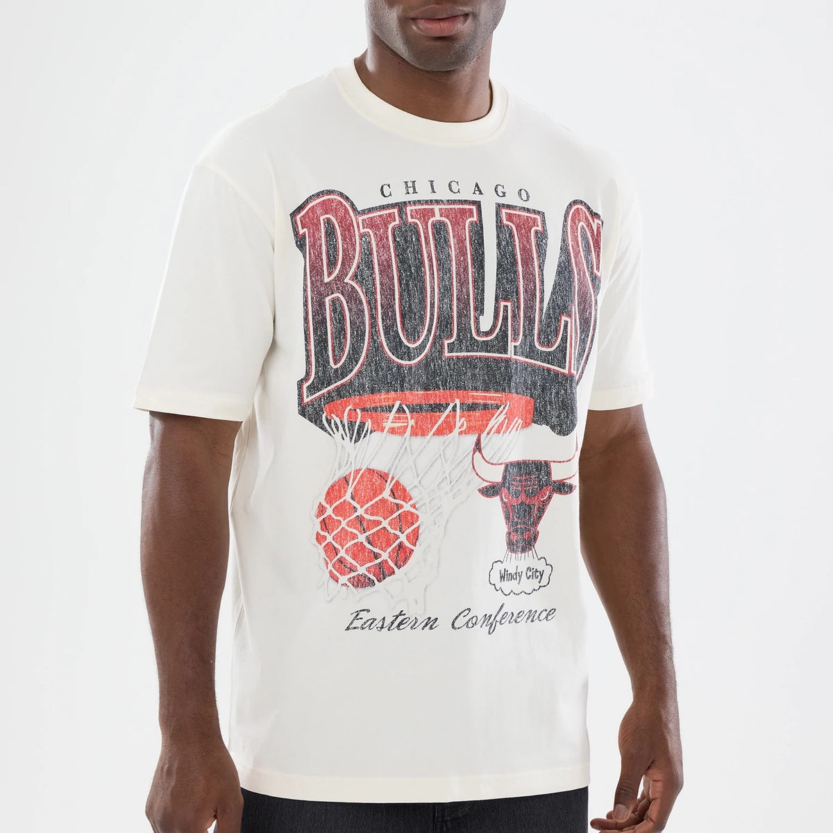 New Era Chicago Bulls NBA Sport Classic Cream T-Shirt, front view on a model featuring a large printed Bulls logo across the chest, with a basketball net graphic and the bull head logo below, complemented by Eastern Conference text.