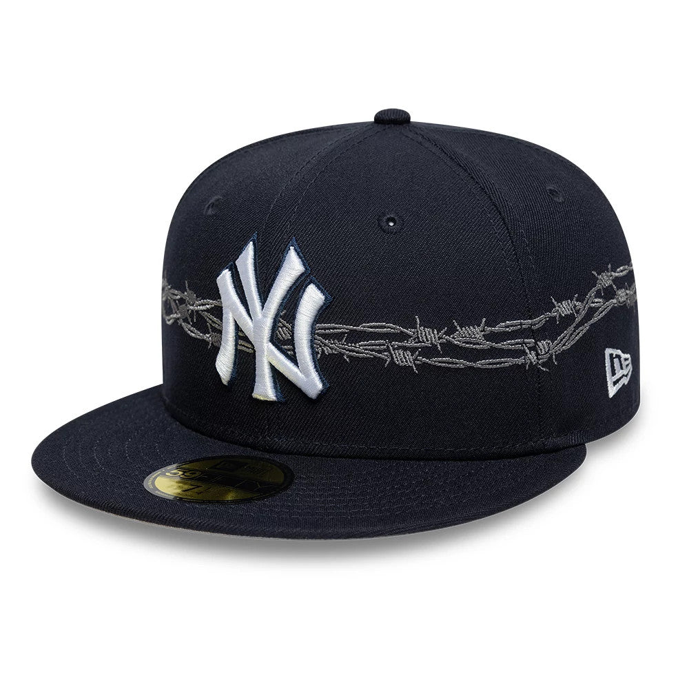 New York Yankees MLB Icon Navy New Era 59FIFTY Fitted Cap, front view showing the white embroidered Yankees logo on the navy front panel, with barbed wire graphic across the crown, and a gold 59FIFTY size sticker on the flat visor.