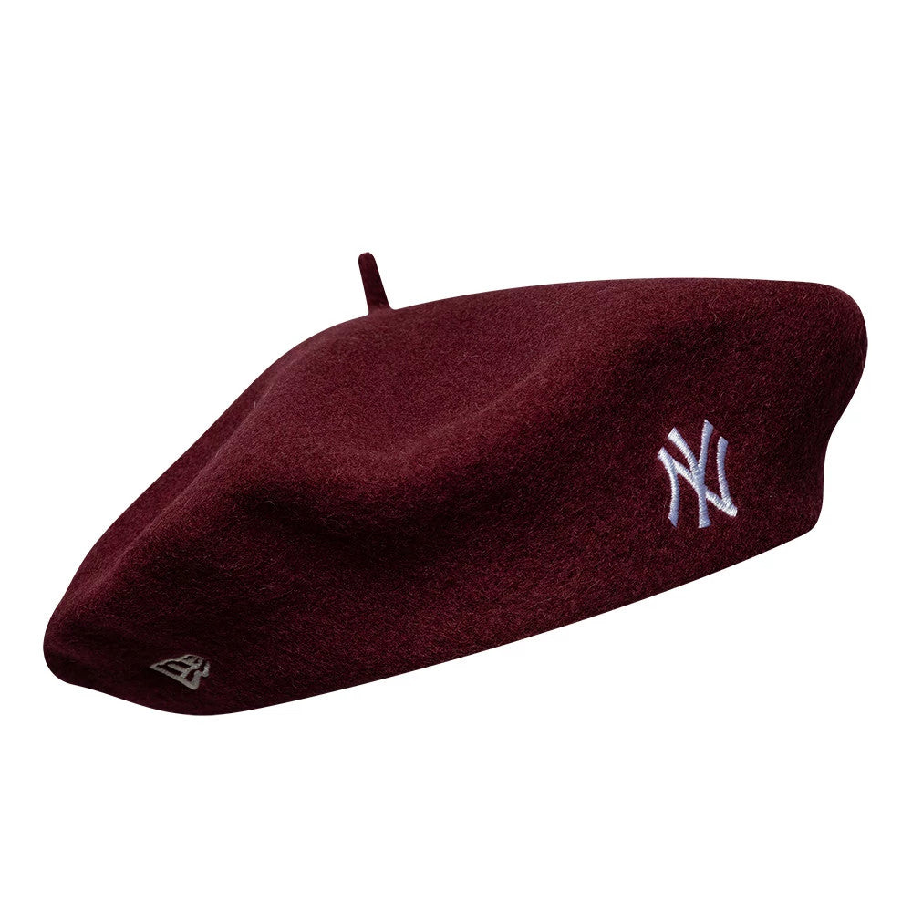 New Era New York Yankees MLB Wool Script Dark Red Beret, side view showing white embroidered NY logo on the side, a rich dark red wool fabric with soft texture, and the New Era flag logo placed towards the rear.