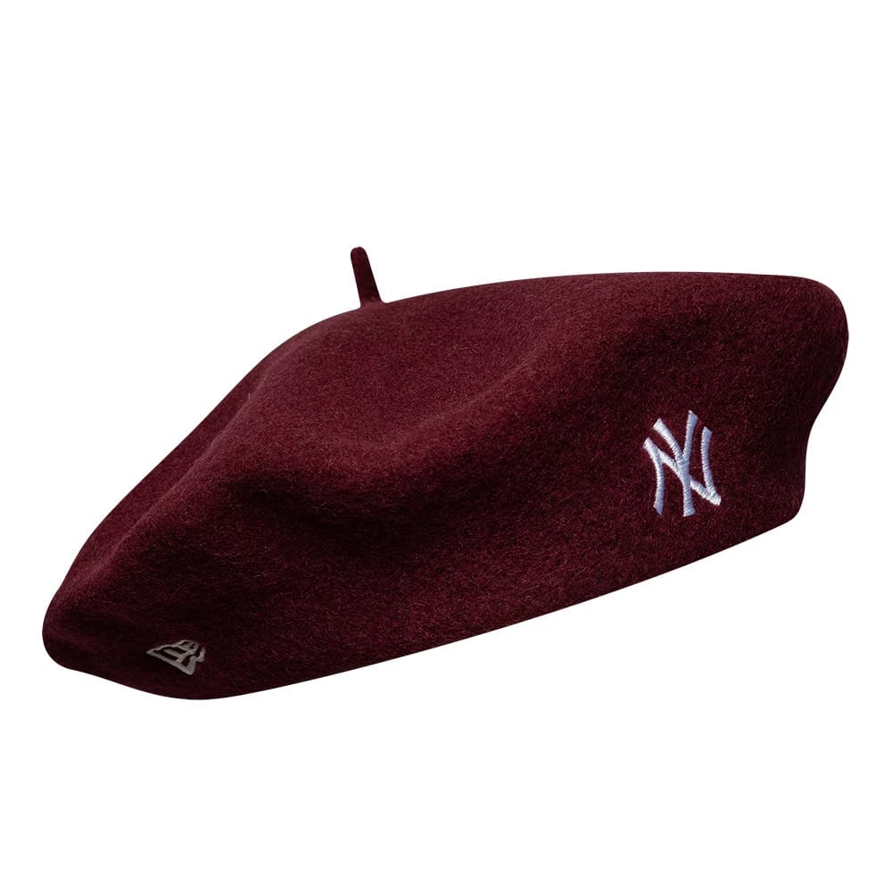 New Era New York Yankees MLB Wool Script Dark Red Beret, side view showing white embroidered NY logo on the side, a rich dark red wool fabric with soft texture, and the New Era flag logo placed towards the rear.