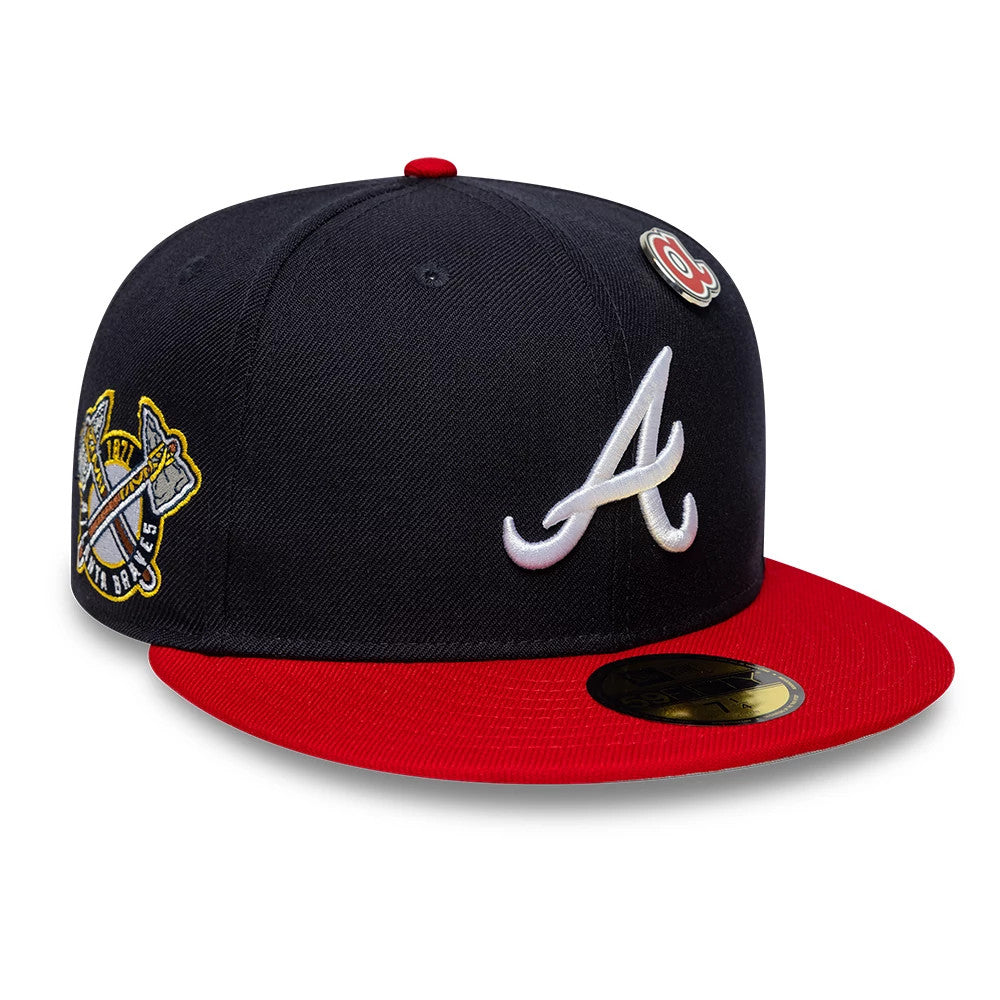 Atlanta Braves MLB Icon Navy & Red New Era 59FIFTY Fitted Cap, three-quarter view showing a raised white embroidered A logo on the front panel, a gold 59FIFTY size sticker on the red visor, and a side patch with crossed tomahawks.