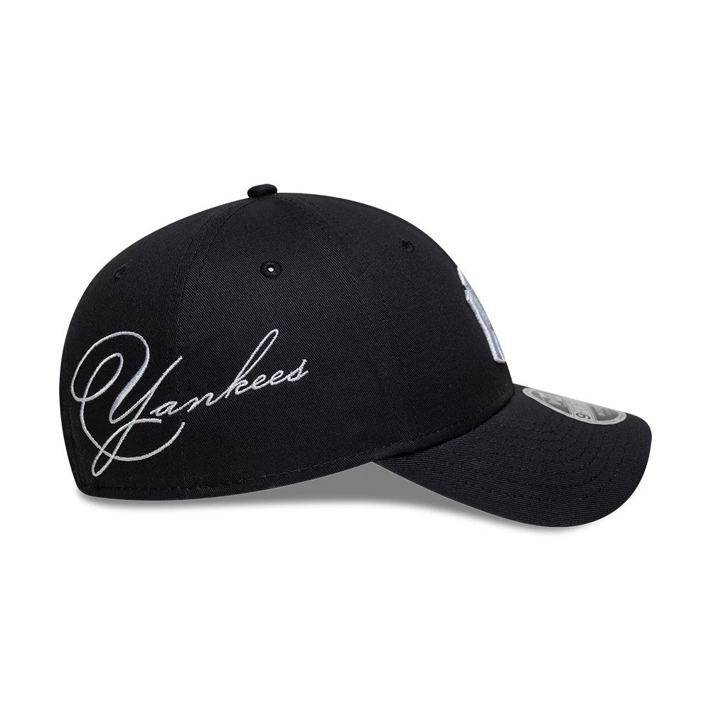 New York Yankees MLB Side Script Navy New Era 9FORTY M-Crown Adjustable Cap, side view showing the Yankees script logo embroidered in white on the navy crown, with a structured curved visor and the 9FORTY size sticker on the dark visor.