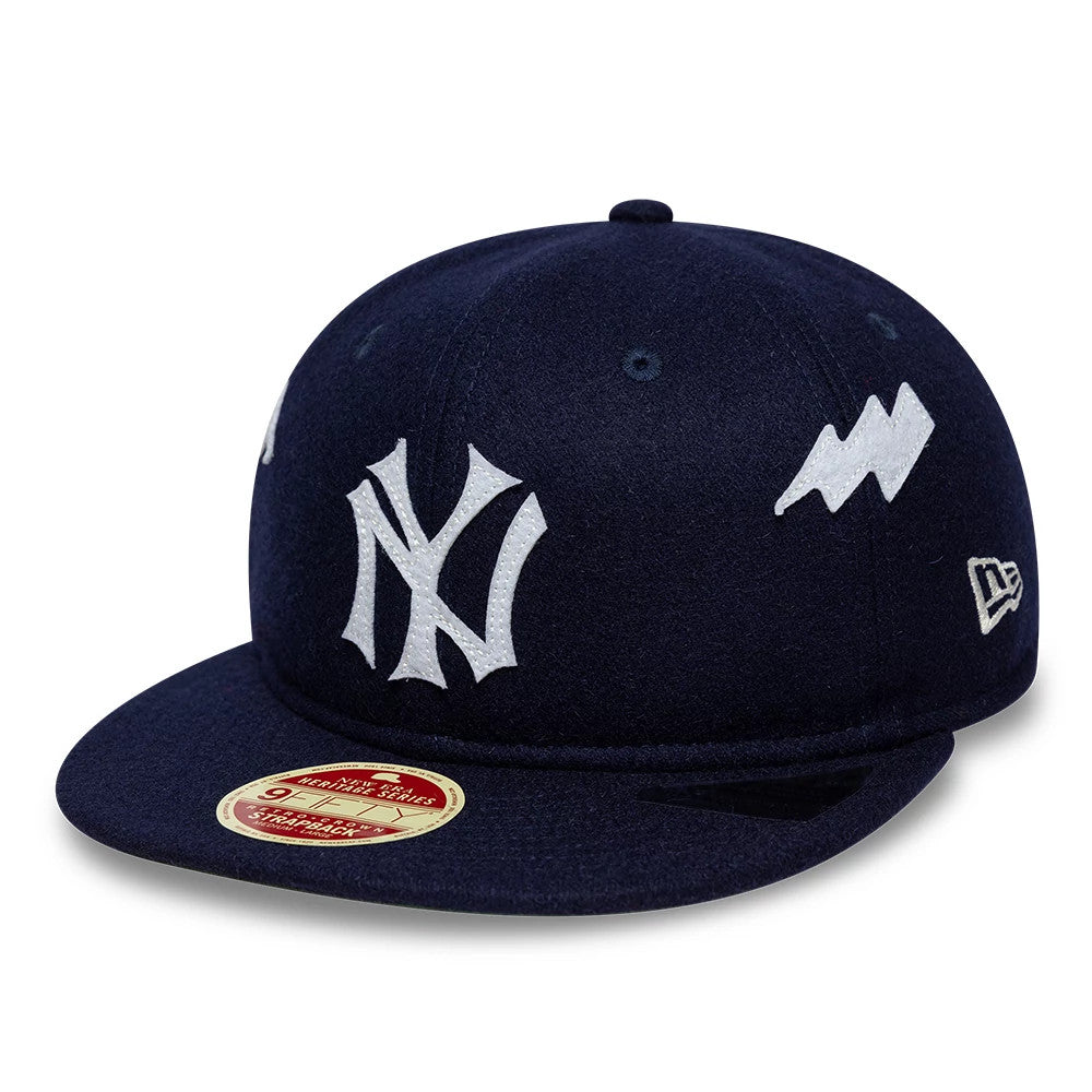 New York Yankees MLB Heritage Navy Retro Crown New Era 9FIFTY Adjustable Cap, three-quarter view showing the white raised embroidered NY logo on the front panel, along with the lightning bolt graphic on the side.