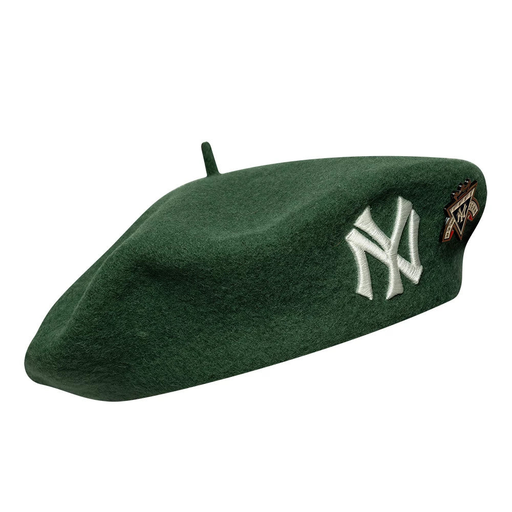 New Era New York Yankees MLB Cooperstown Pin Dark Green Beret, side view showing the dark green beret with a prominent embroidered white NY logo on the side, a decorative pin featuring MLB graphics near the logo, and a small top stem.