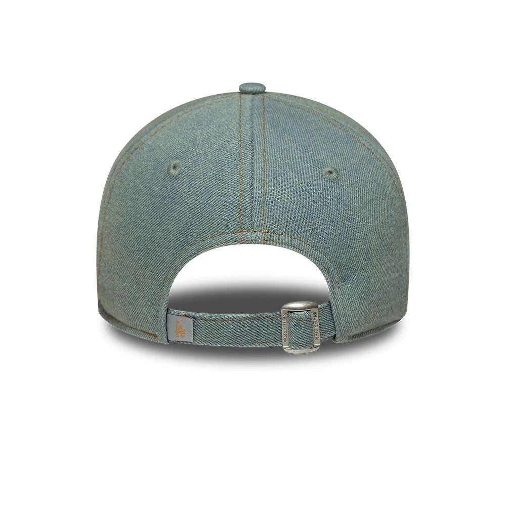 LA Dodgers Womens MLB Denim Pastel Blue New Era 9TWENTY Adjustable Cap, rear view showing the orange LA embroidered logo on the light grey strap, buckle closure, and pastel blue denim fabric with exposed stitching and embroidered eyelets.