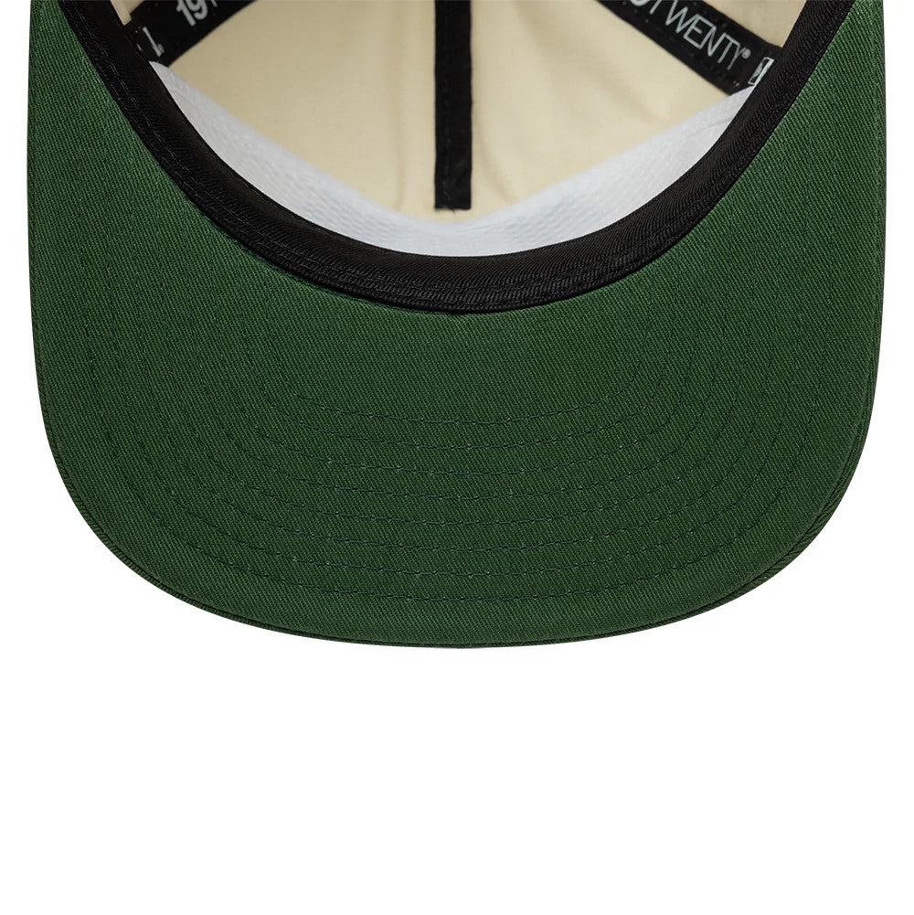 New Era Washed Graphic Cream & Green 19TWENTY Adjustable Cap, inside view showing the black sweatband against a cream lining, green undervisor, and black taping with white 19TWENTY lettering.