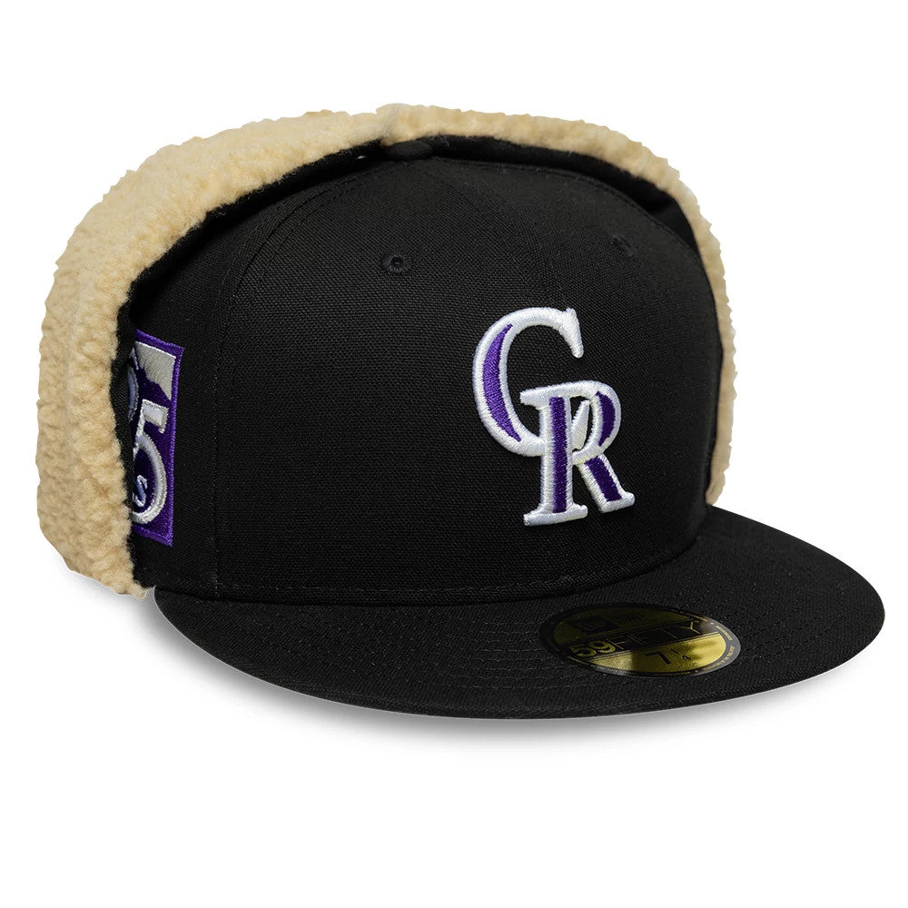 Colorado Rockies MLB World Series Black Dogear New Era 59FIFTY Fitted Cap, three-quarter view showing the raised white and purple embroidered CR logo on the front panel, gold 59FIFTY size sticker on the black visor, and beige faux fur dogear flaps.