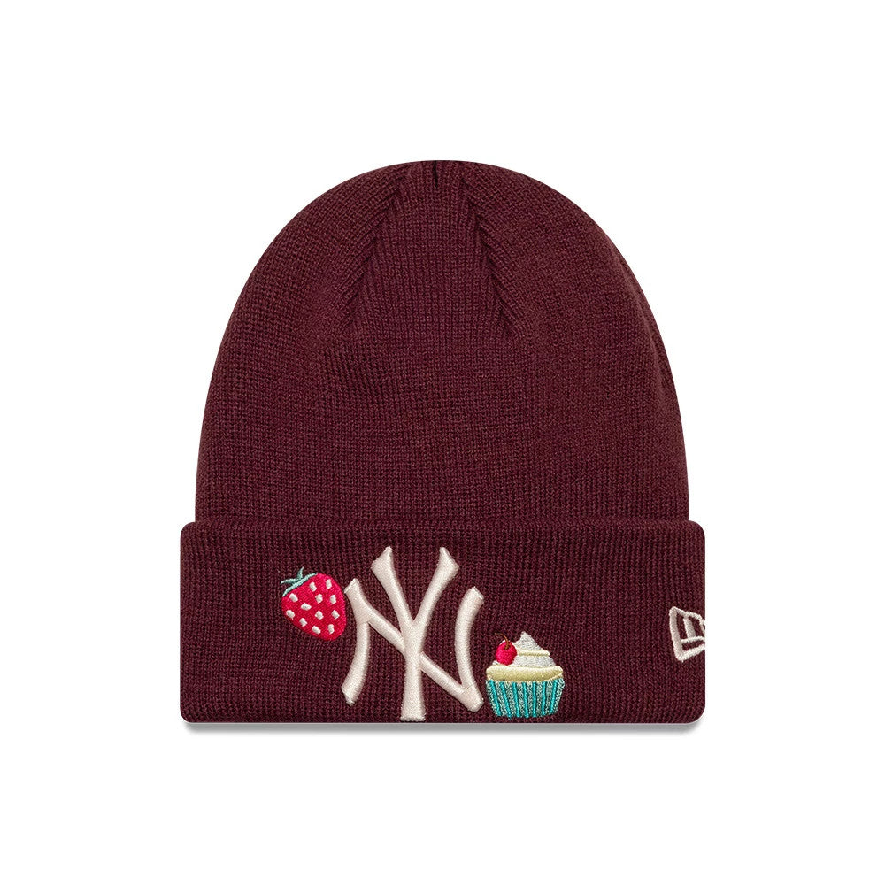 New Era New York Yankees Child MLB Food Icon Dark Red Cuff Knit Beanie Hat, front view showing the embroidered white Yankees logo on the cuff between colourful strawberry and cupcake graphics, and the New Era flag logo on the side.