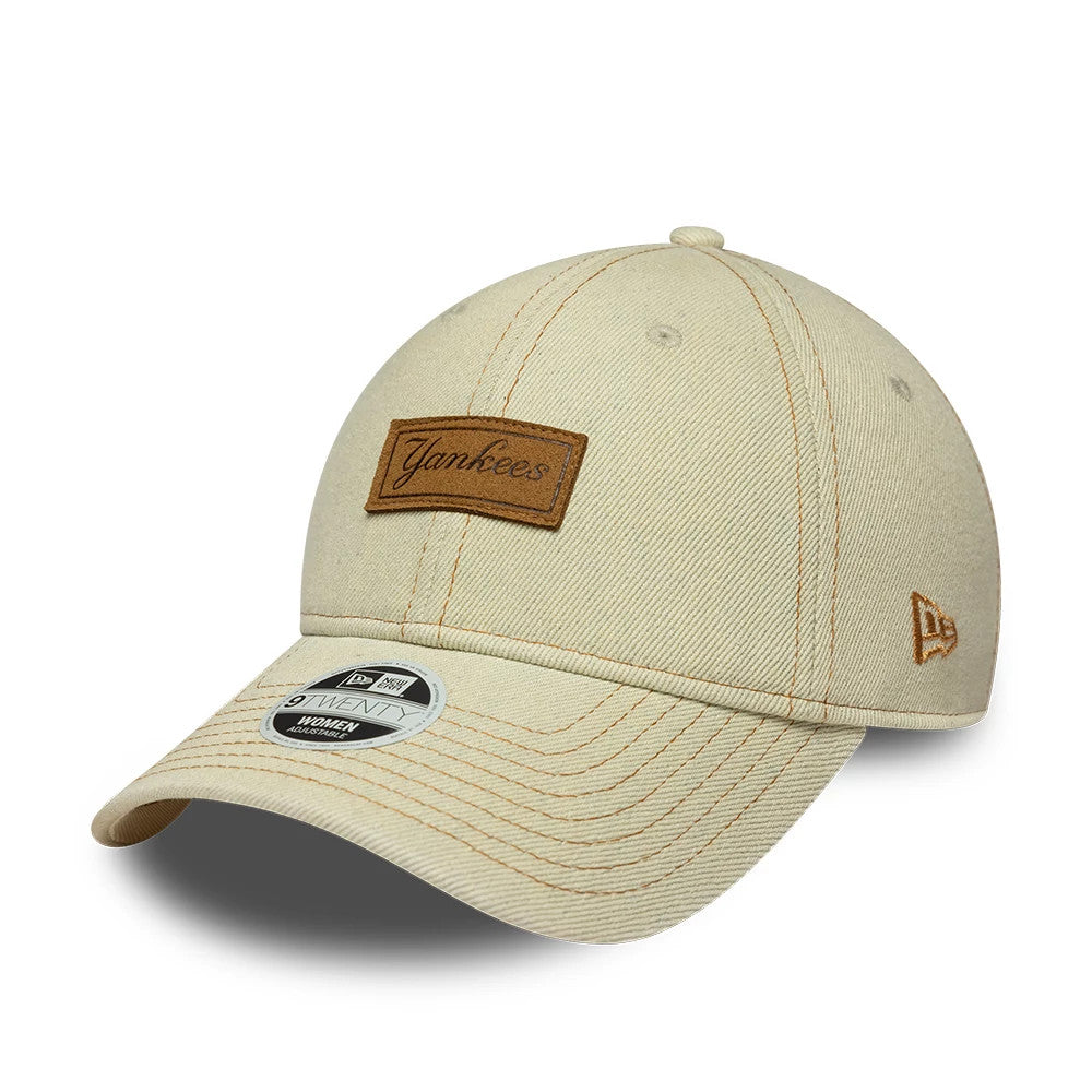 New York Yankees Womens MLB Denim Cream New Era 9TWENTY Adjustable Cap, three-quarter view showing a brown Yankees patch on the front panel, cream visor featuring a 9TWENTY size sticker, and an embroidered New Era flag on the left side.
