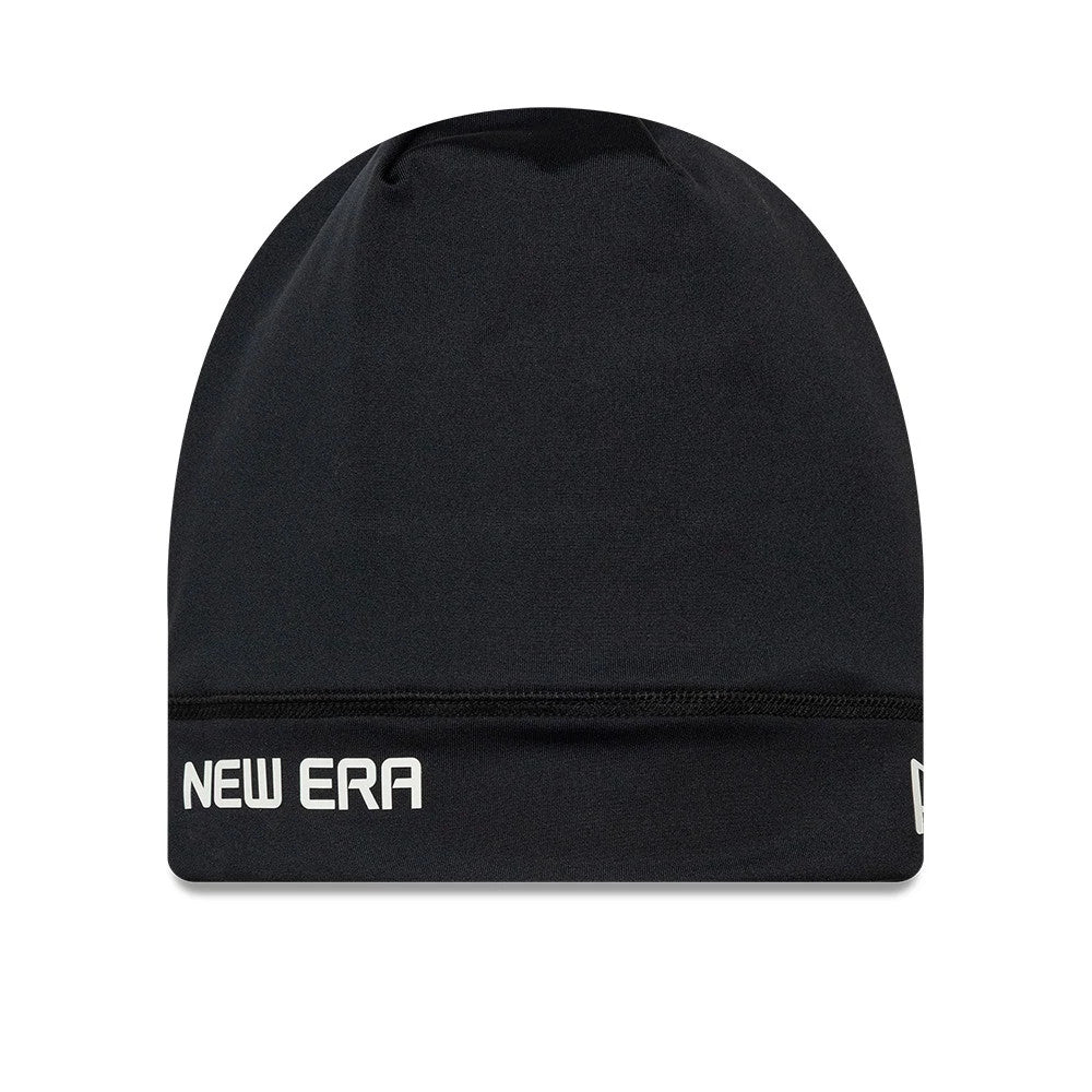 New Era Sport Black Skull Knit Beanie Hat, front view showing white New Era lettering in on the lower left side, a seamless black crown with a gathered design at the top, and a small New Era flag logo on the lower right.