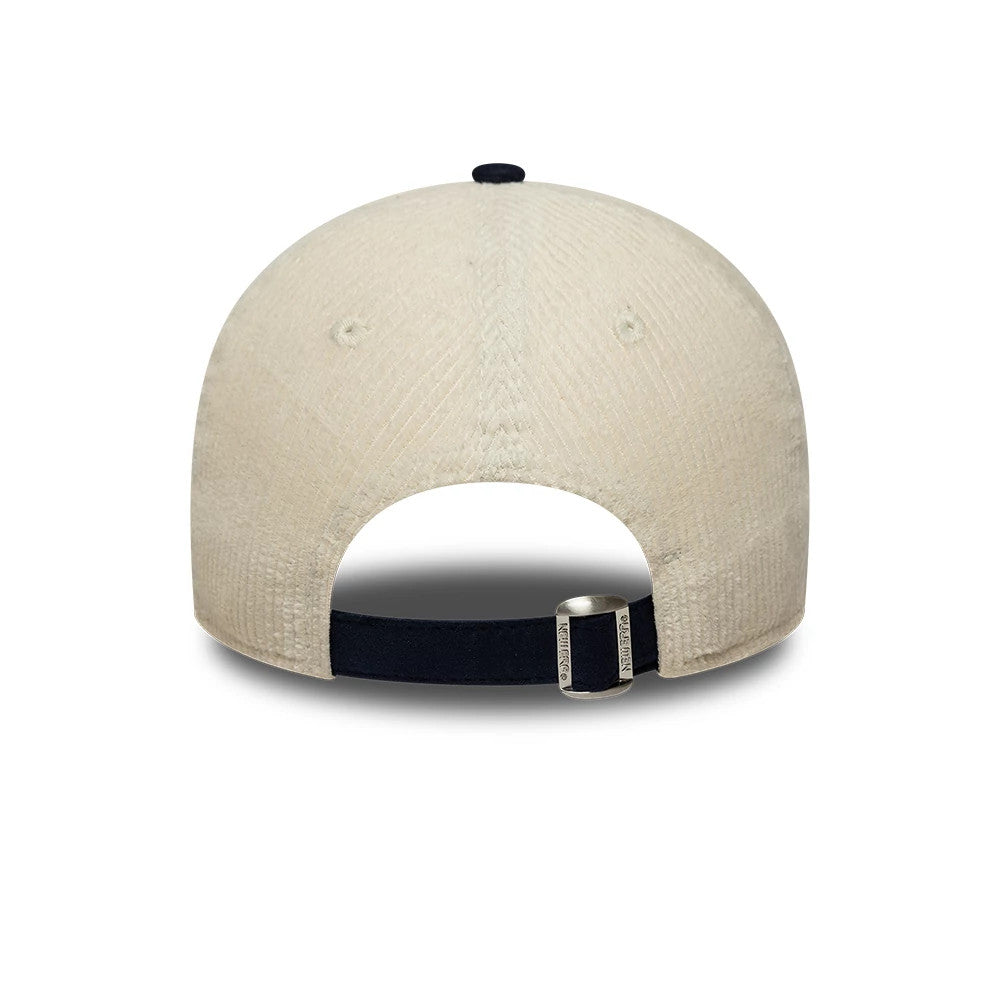 New Era Cord Mix Cream & Navy 9TWENTY Adjustable Cap, rear view showing the cream corduroy fabric on the crown, a navy strap with a buckle for adjustment, and the top button in navy matching the strap.