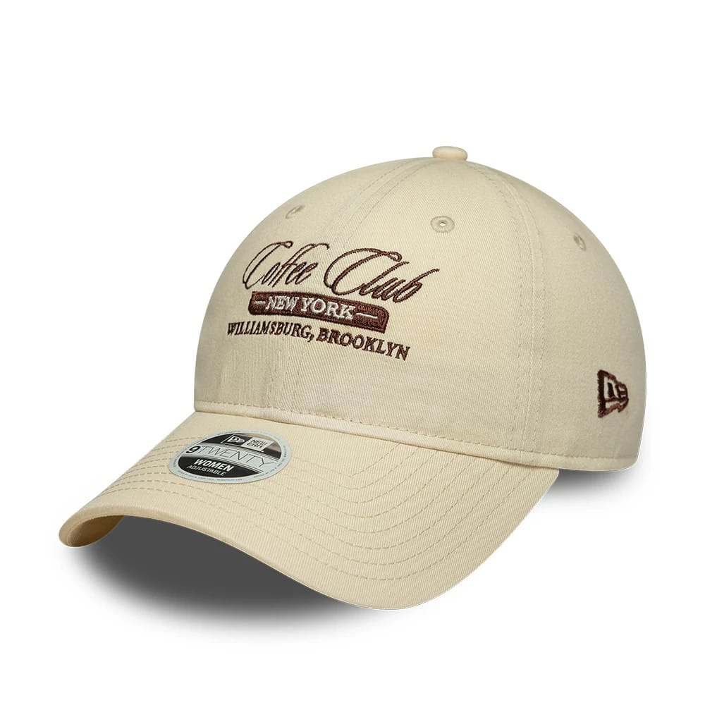 Pictured is this Womens New Era Café Slogan 9TWENTY cap in cream. 1
