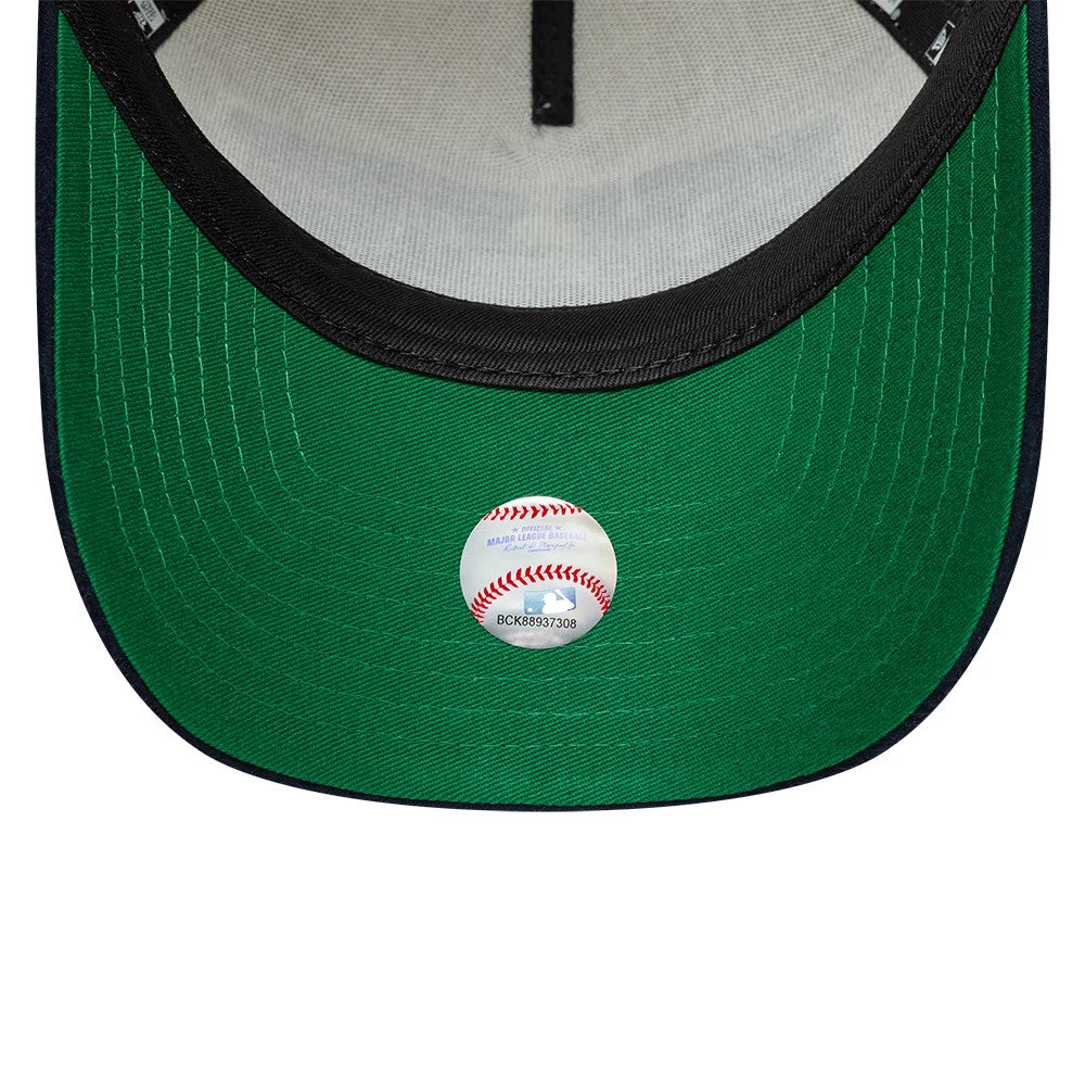New York Yankees MLB Suede Cream & Navy New Era 9FORTY E-Frame Adjustable Cap, inside view showing the green undervisor with an MLB authentication sticker, black sweatband with logo taping, and light grey panel lining.
