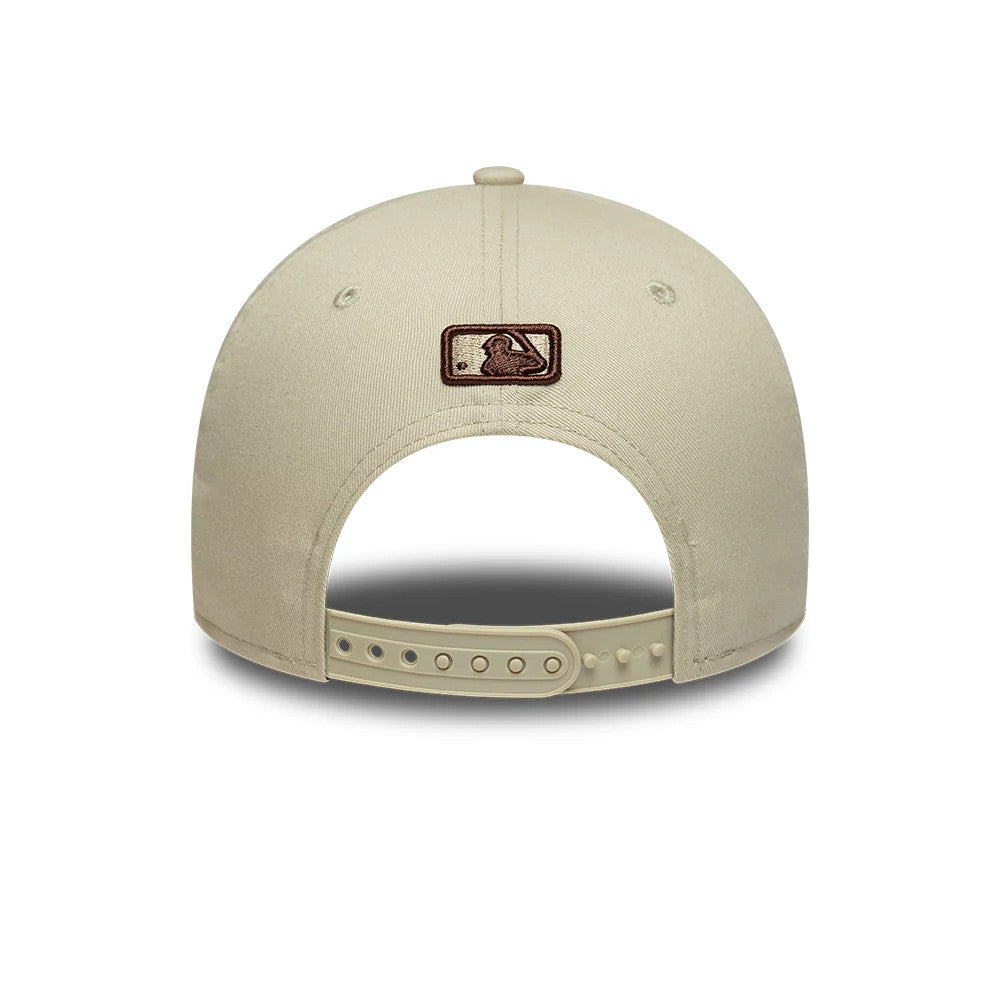 New York Yankees MLB Cream New Era 9FORTY M-Crown Adjustable Cap, rear view showing the brown embroidered MLB Batterman logo at the centre back of the structured cream crown, with a cream adjustable strap and matching top button.