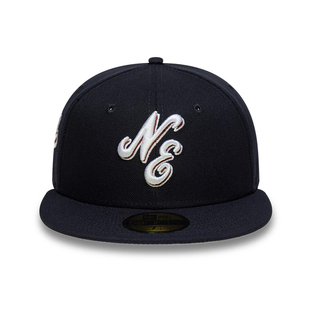 New Era Heritage Script Navy 59FIFTY Fitted Cap, front view showing the silver and white embroidered NE logo on the structured navy crown, with a flat visor and a gold 59FIFTY size sticker at the centre front.