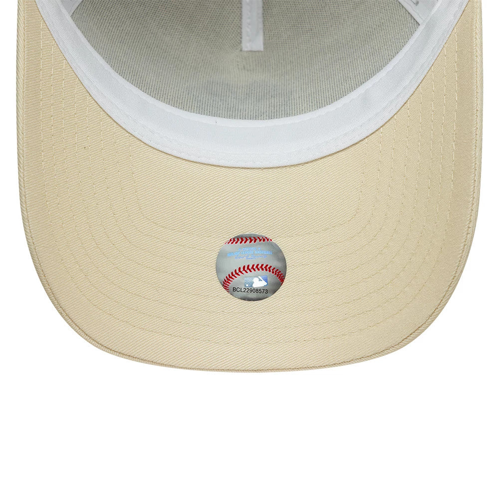 New York Yankees MLB Outline Cream New Era 9FORTY E-Frame Trucker Adjustable Cap, inside view showing the cream undervisor with detailed stitching and a baseball-themed sticker, featuring white interior taping.
