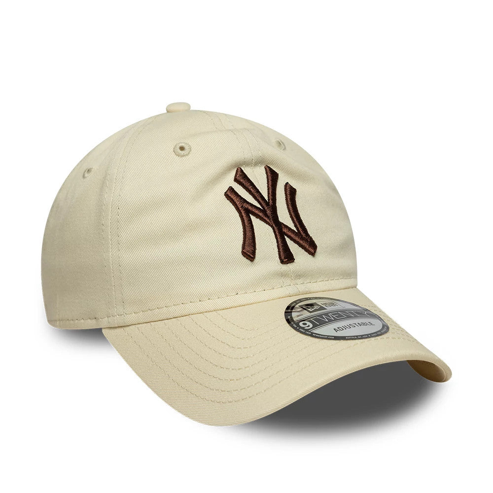 New York Yankees MLB League Essential Cream New Era 9TWENTY Adjustable Cap, front view showing the brown embroidered NY logo on the cream curved visor, with a 9TWENTY size sticker placed on top, and matching cream eyelets and button.