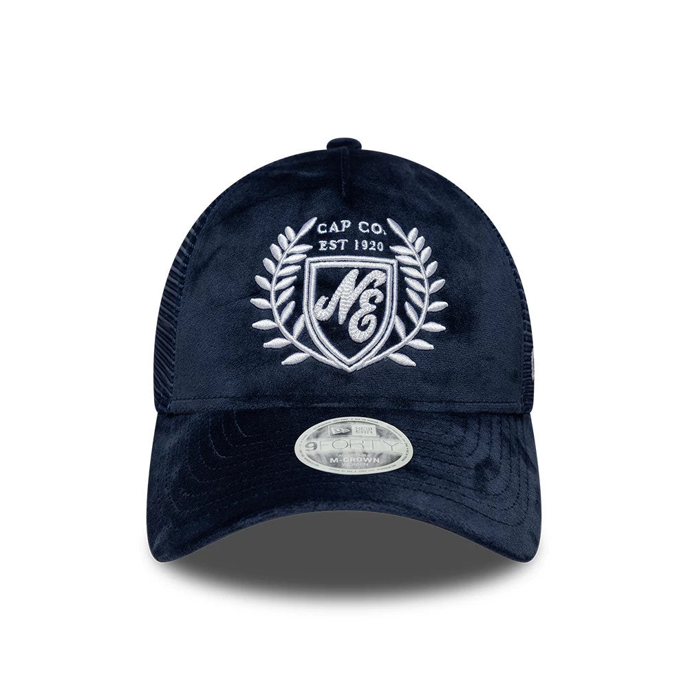Womens New Era Velour Navy 9FORTY M-Crown A-Frame Trucker Adjustable Cap, front view showing a white embroidered crest on the navy velour front panel, a curved black visor with a 9FORTY size sticker, and a mesh rear section.