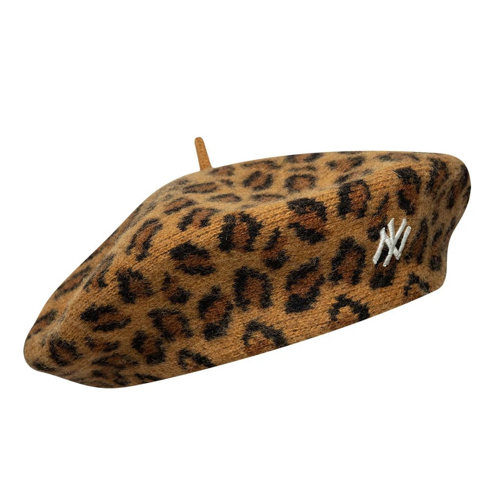 New Era New York Yankees MLB Leopard Beige Beret, front three-quarter view showing the beige leopard print pattern across the entire beret, the white embroidered NY logo on the side, and the small top nub in matching fabric.