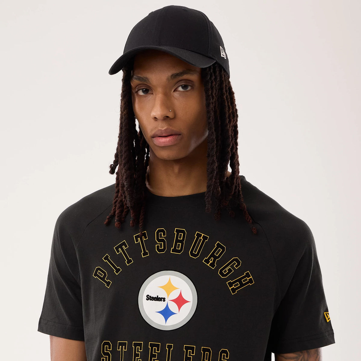 New Era Pittsburgh Steelers NFL Sideline 2026 Black T-Shirt, front view on-model showing the PITTSBURGH STEELERS arched lettering in yellow with the team emblem centred on the chest.