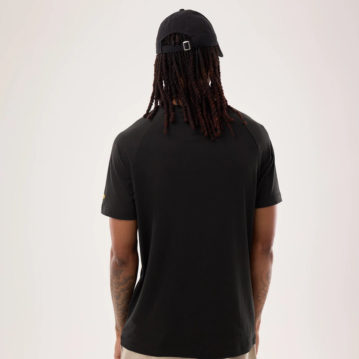 New Era Pittsburgh Steelers NFL Sideline 2026 Black T-Shirt, back view on a model sporting the plain black design with a appearance, showing a small printed New Era logo on the left sleeve and a relaxed fit silhouette.