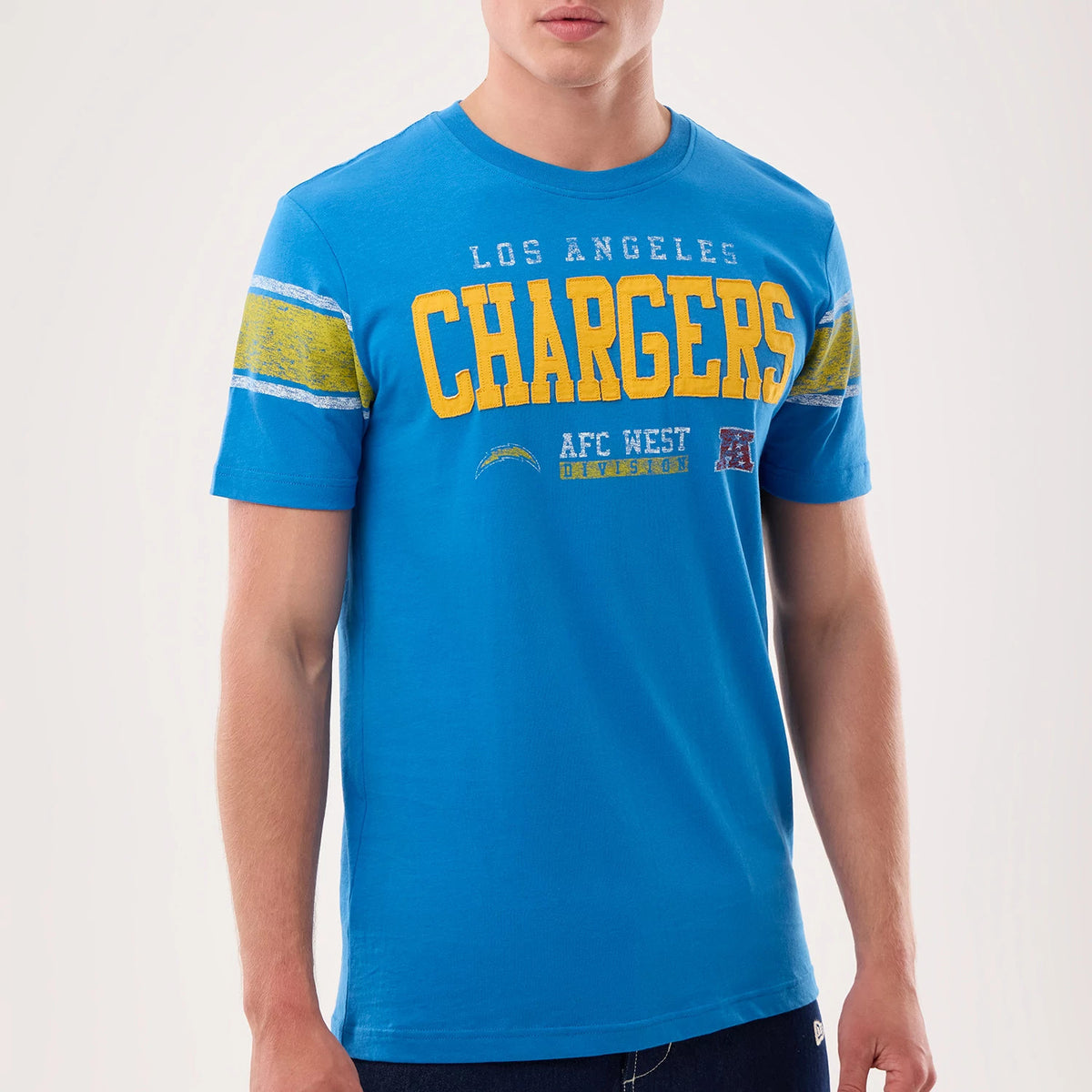 New Era LA Chargers NFL Sideline 2026 Blue T-Shirt, front view on a model displaying a blue tee with yellow Chargers lettering across the chest, complemented by distressed stripes on the sleeves and additional team graphics below.