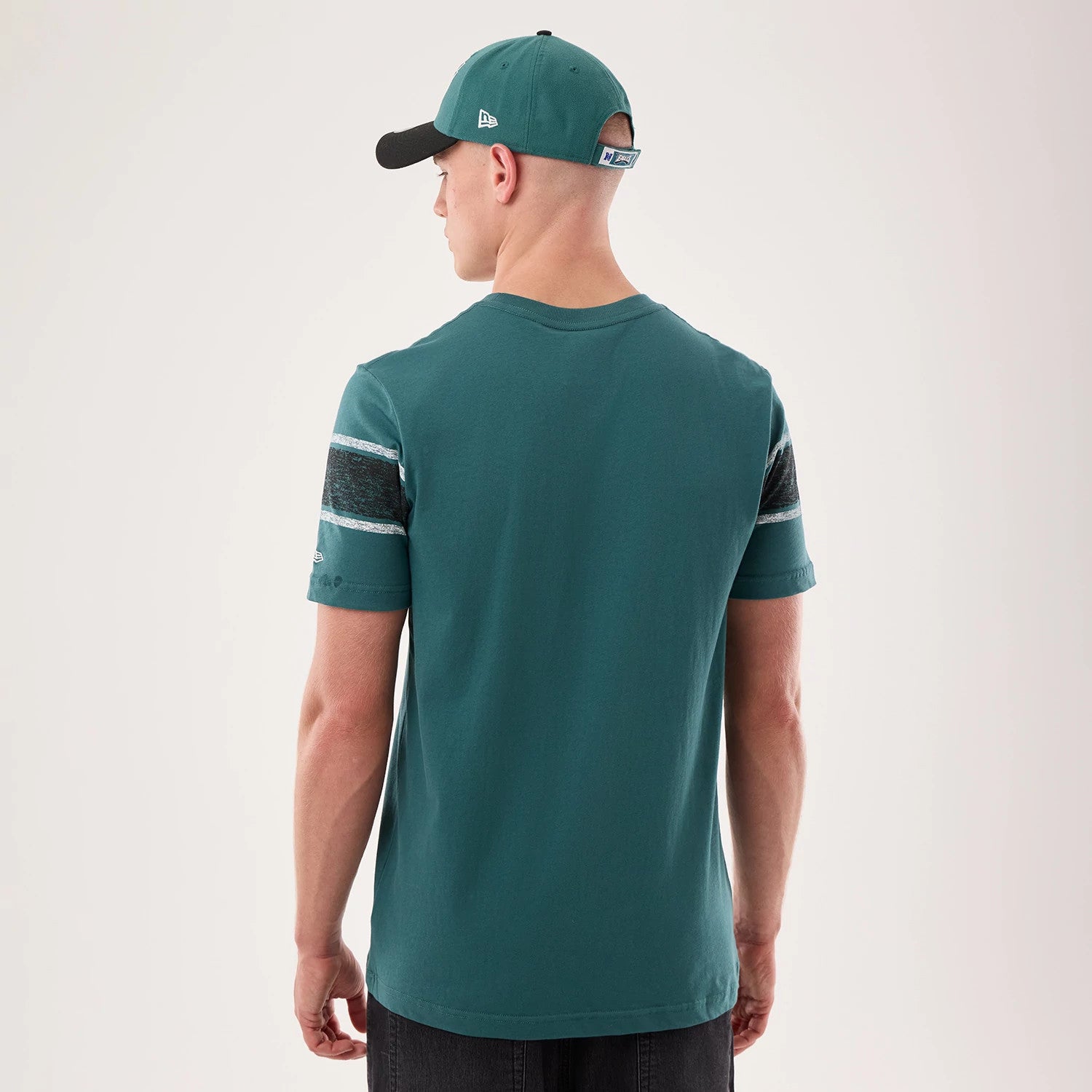 The model is wearing this NFL Sideline 2026 Philadelphia Eagles T-Shirt in dark green. 2