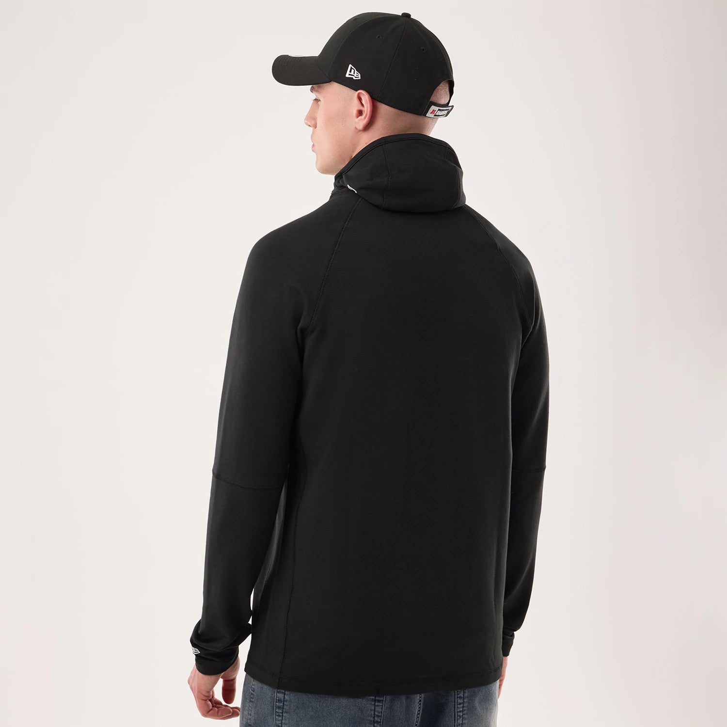 The model is wearing this NFL Sideline 2026 Las Vegas Raiders Balaclava Hoodie in black. 2