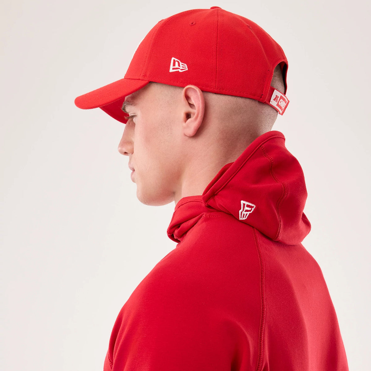The model is wearing this NFL Sideline 2026 Kansas City Chiefs Balaclava Hoodie in red. 7