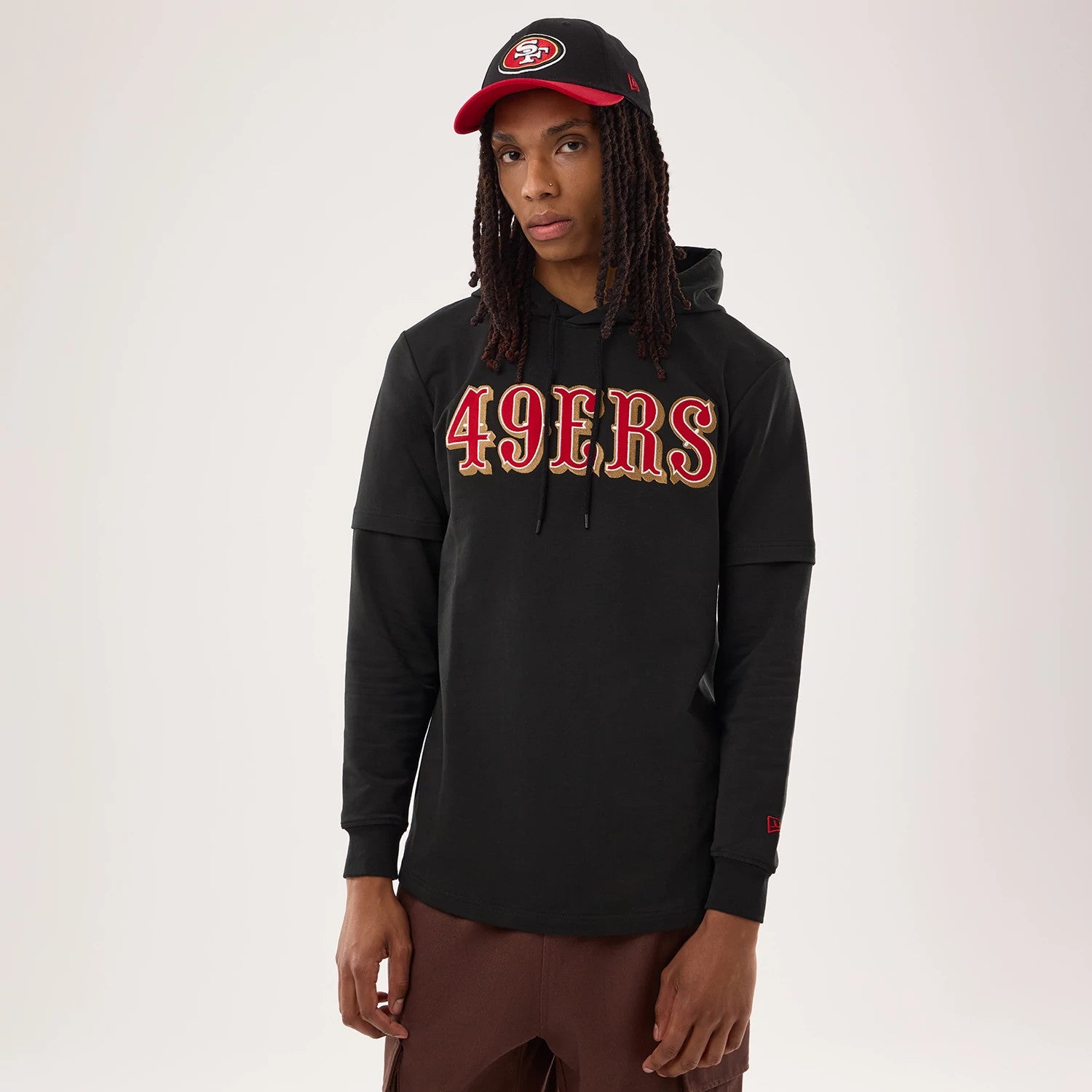 The model is wearing this NFL Sideline 2026 San Francisco 49ers Double Sleeve Hoodie in black. 1