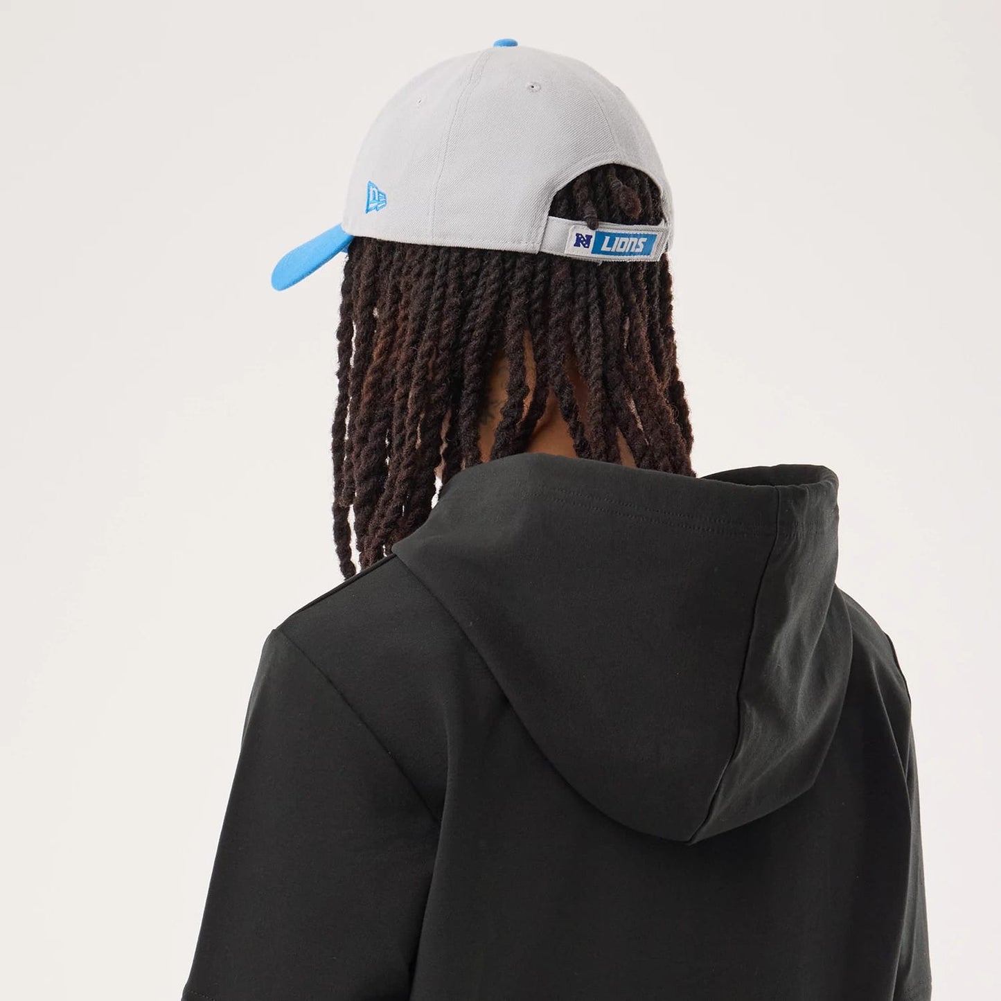 The model is wearing this NFL Sideline 2026 Detroit Lions Double Sleeve Hoodie in black. 7