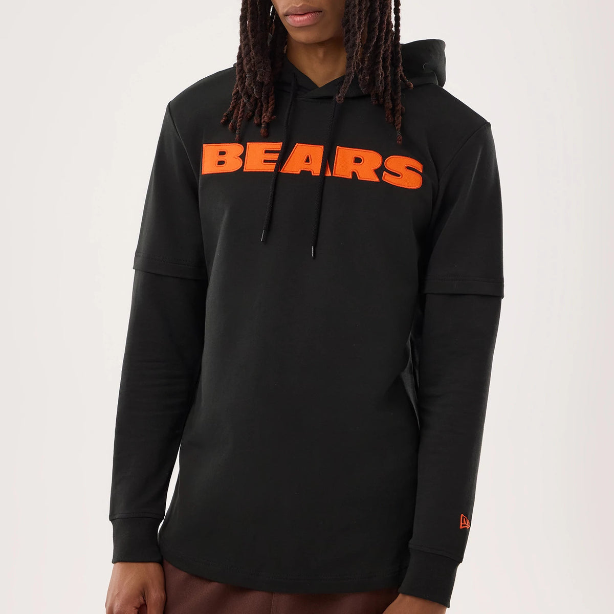 New Era Chicago Bears NFL Sideline 2026 Black Double Sleeve Hoodie, front view on a model featuring orange BEARS lettering across the chest, a double-layer sleeve design, black drawstrings on the hood.