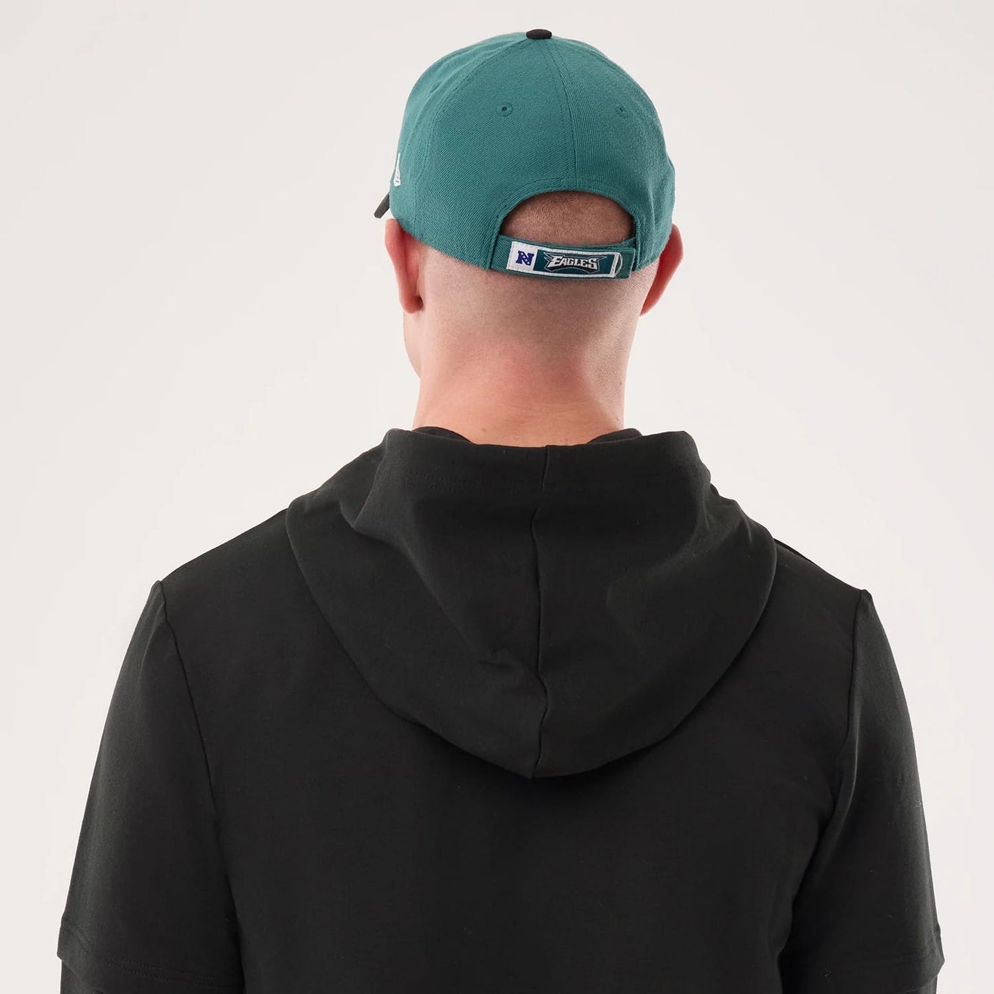 The model is wearing this NFL Sideline 2026 Philadelphia Eagles Double Sleeve Hoodie in black. 7