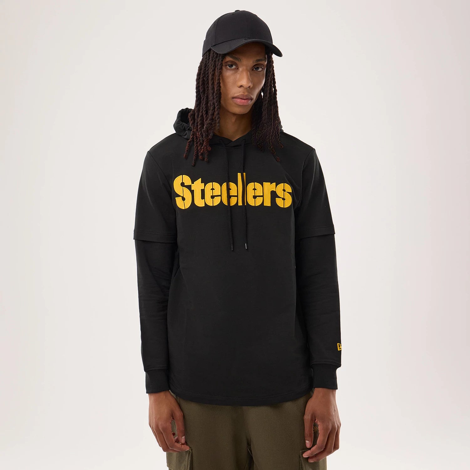 The model is wearing this NFL Sideline 2026 Pittsburgh Steelers Double Sleeve Hoodie in black. 1