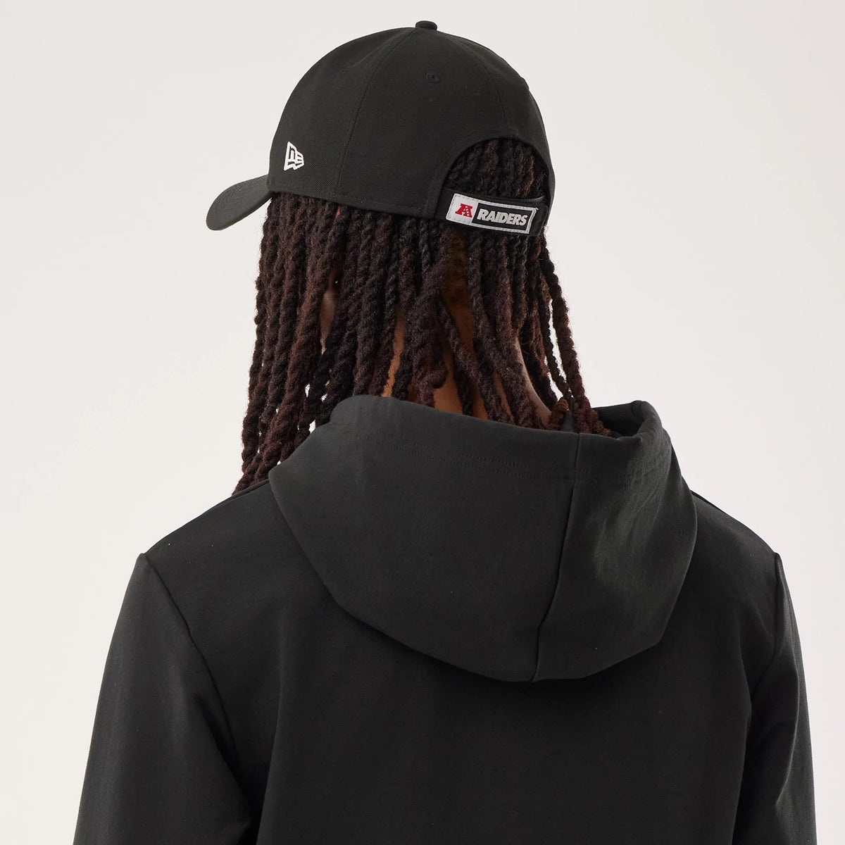 The model is wearing this NFL Sideline 2026 Las Vegas Raiders Double Sleeve Hoodie in black. 7