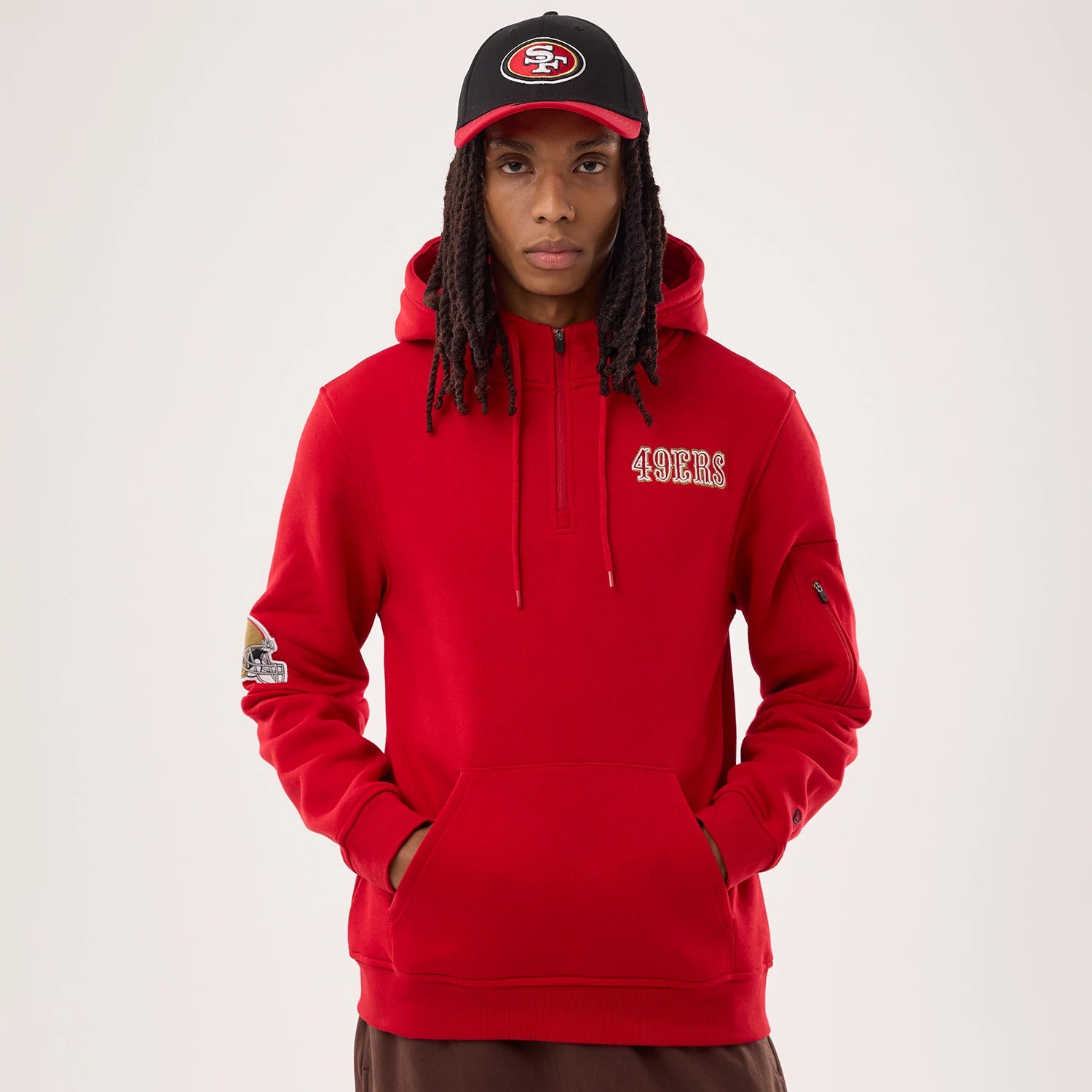 The model is wearing this NFL Sideline 2026 San Francisco 49ers Pullover Hoodie in red. 1