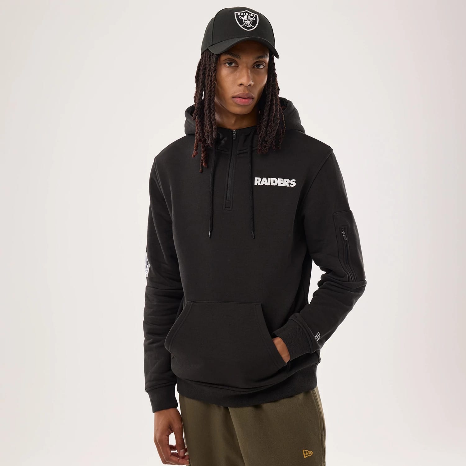 The model is wearing this NFL Sideline 2026 Las Vegas Raiders Pullover Hoodie in black. 1