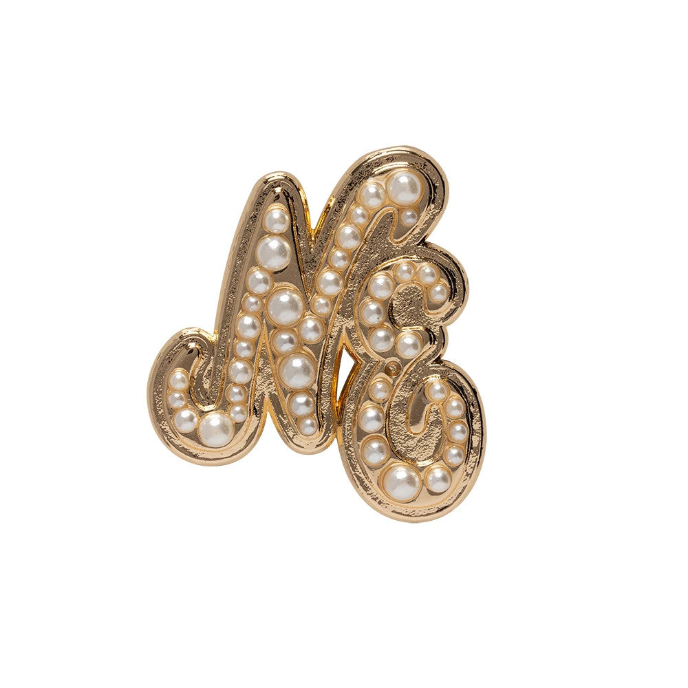 New Era Faux Pearl Gold Pin Badge, front view showing a stylised gold NE adorned with faux pearls embedded across the surface, highlighting the intricate and elegant swirl design of the badge.