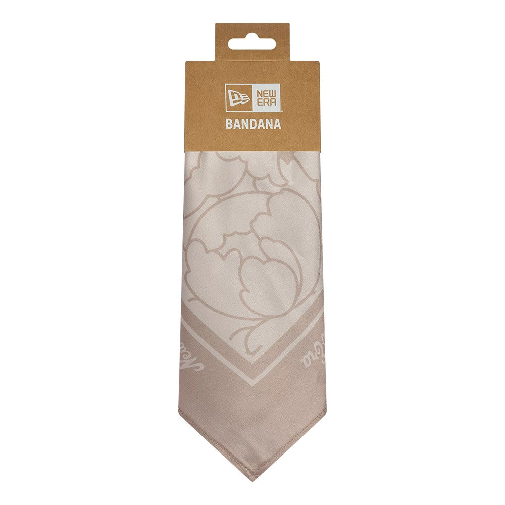 New Era Floral Satin Beige Bandana, front view showing a delicate floral pattern in a light beige shade on satin fabric, packaged with a brown cardboard hanger, and featuring the New Era wordmark and logo at the top.