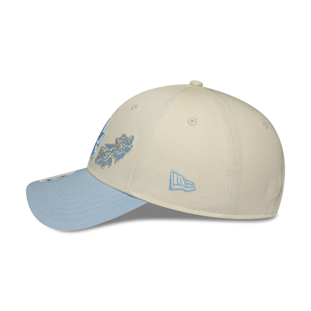 LA Dodgers Womens MLB Floral Cream New Era 9FORTY Adjustable Cap, side view showing the light blue New Era flag logo embroidered on the left side, a light blue floral graphic on the cream crown, and a curved light blue visor.