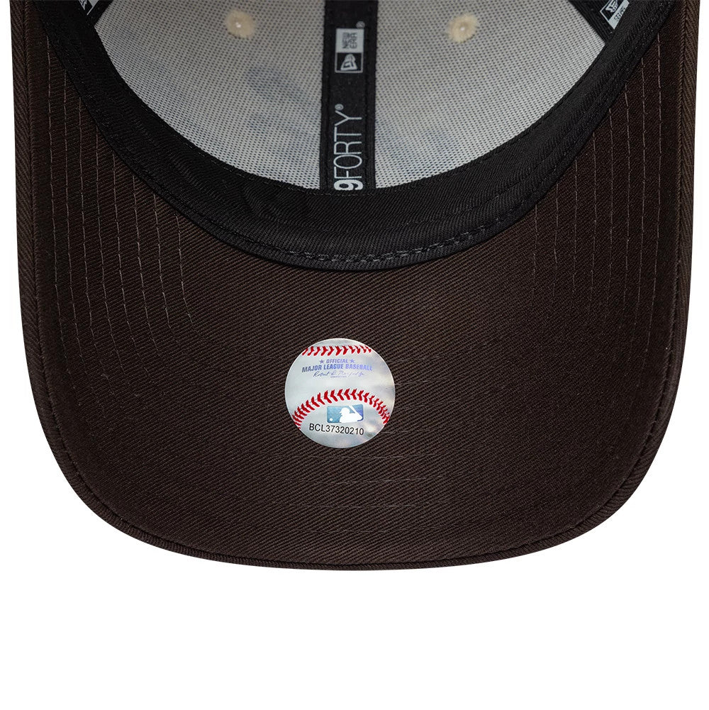 Womens New Era Floral Light Beige 9FORTY Adjustable Cap, inside view showing light grey taping with 9FORTY logo, contrasting black sweatband, and black undervisor with a round MLB sticker at the centre near the edge.