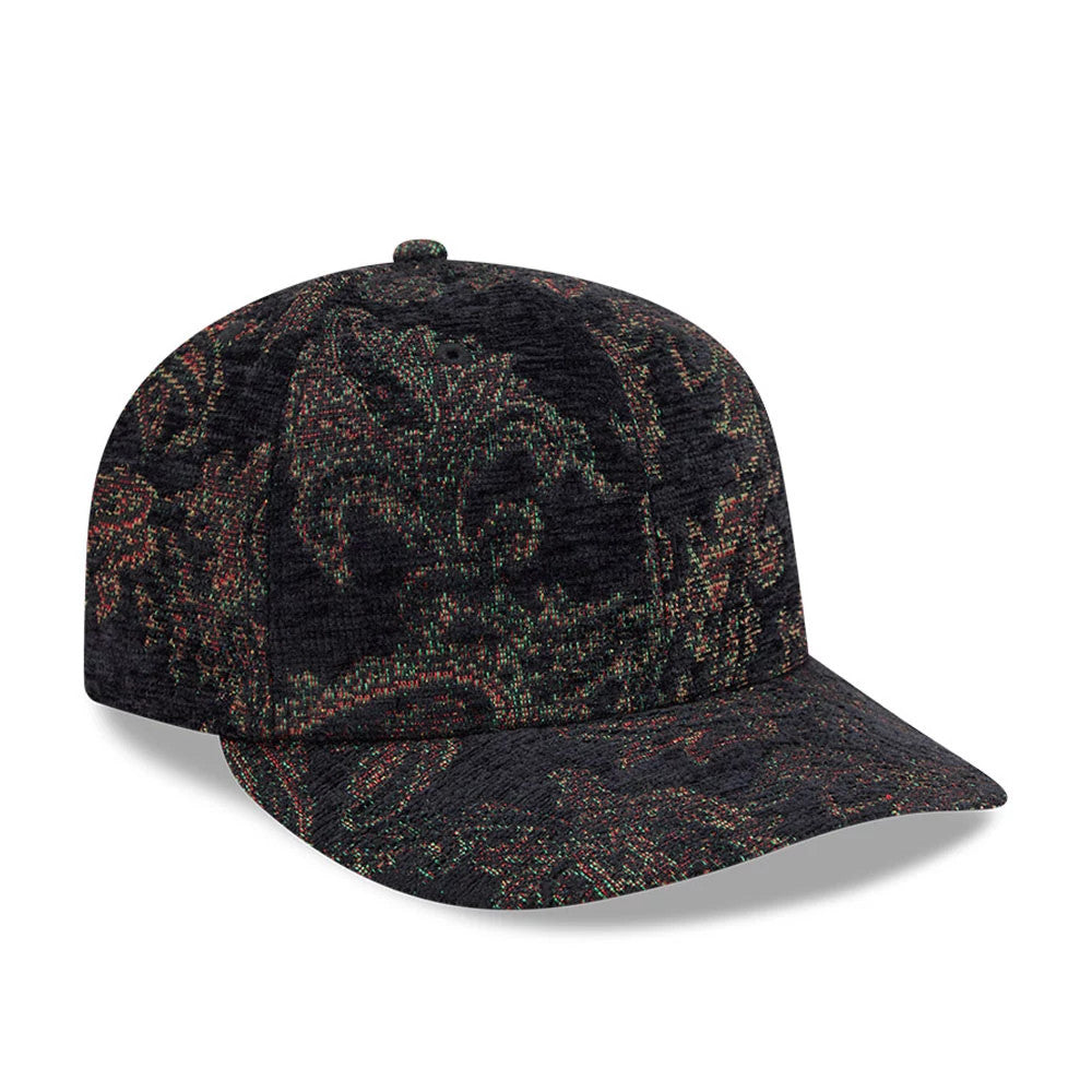 New Era Jacquard Chenille Black 59FIFTY Fitted Cap, front view showing an intricate jacquard pattern in green and red tones across the structured black crown and matching flat visor, with the classic embroidered eyelets and top button.
