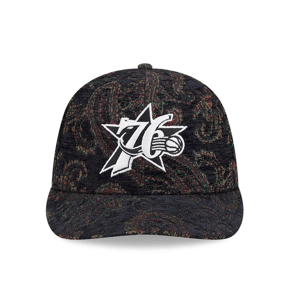 Philadelphia 76ers NBA Jacquard Chenille Black New Era 59FIFTY Fitted Cap, front view showing the prominent white embroidered 76ers logo on the structured black crown with a multi-coloured paisley pattern and a matching black curved visor.