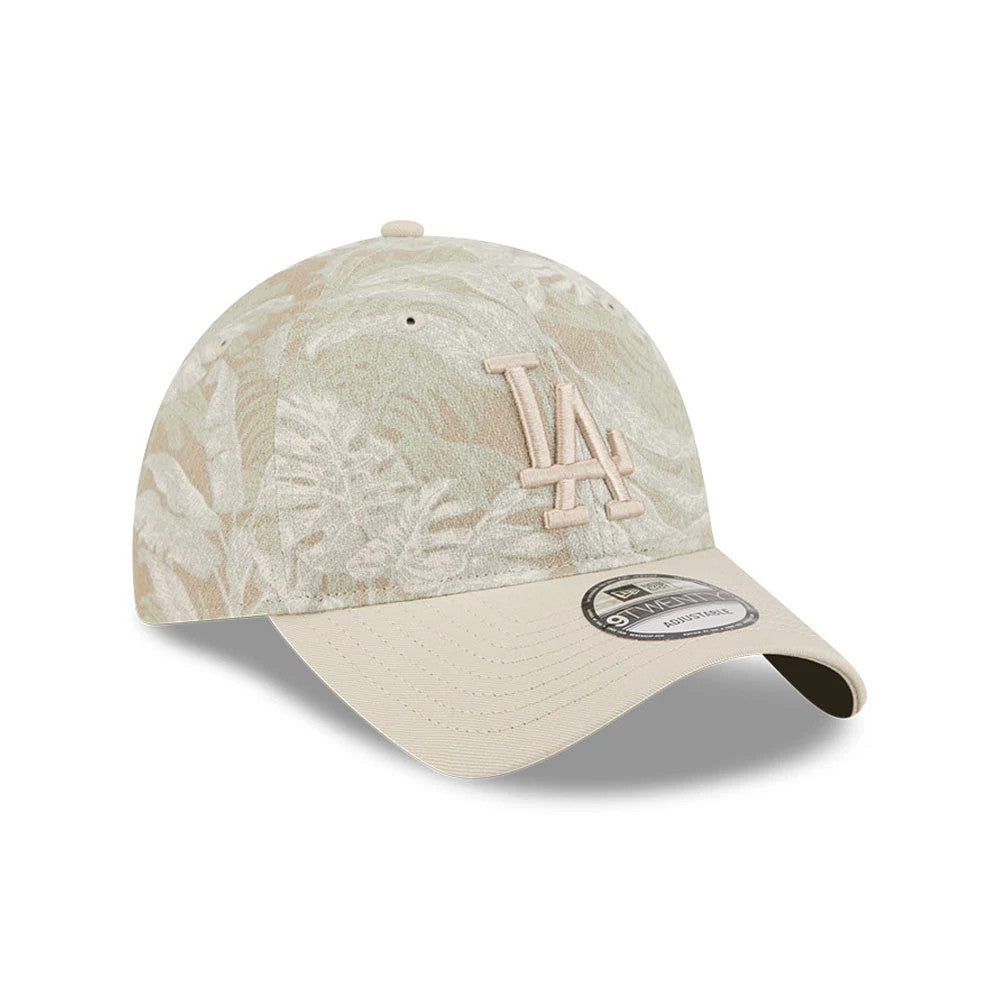 LA Dodgers MLB Leafy Palm Light Beige New Era 9TWENTY Adjustable Cap, three-quarter view showing a beige embroidered LA logo on a leafy palm-patterned crown, complemented by a light beige curved visor and a 9TWENTY size sticker.