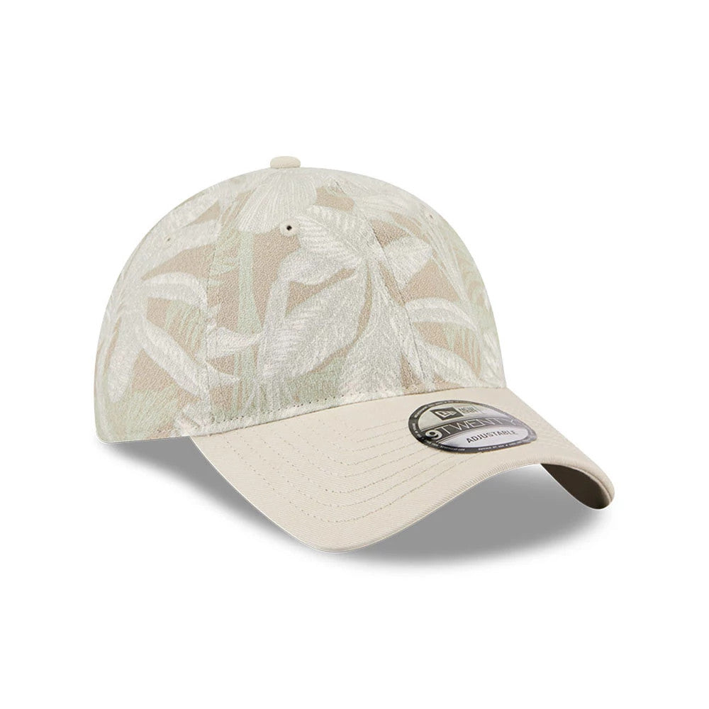 New Era Leafy Palm Light Beige 9TWENTY Adjustable Cap, three-quarter view showing a leaf print pattern on the unstructured crown, beige curved visor with a 9TWENTY size sticker, and matching top button and eyelets.