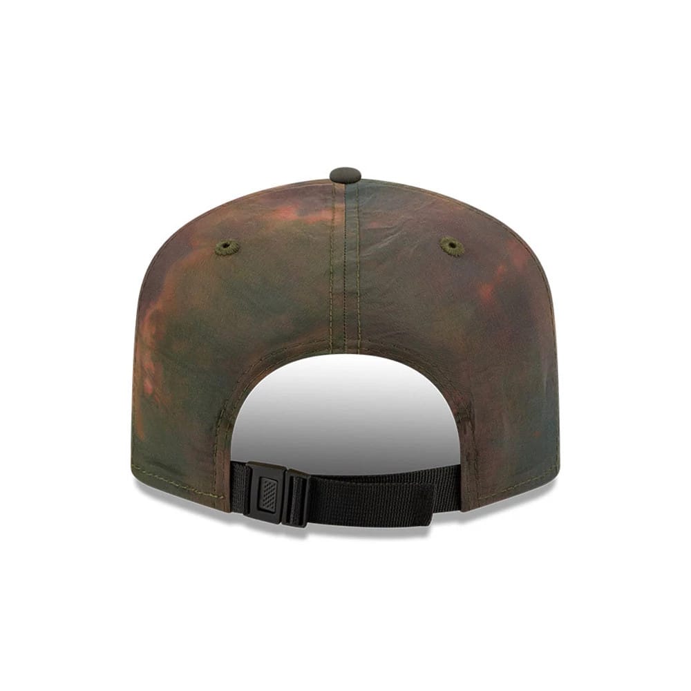New Era Nylon Wash Dye Open Green 19TWENTY Adjustable Cap, rear view showing a faded wash dye pattern on the lightly structured crown, two embroidered eyelets, and a black adjustable strap with a buckle for a customised fit.