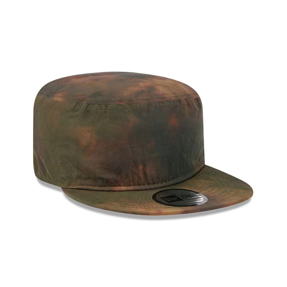 New Era Nylon Wash Dye Open Green Painter Cap, three-quarter view showing the green and brown mottled nylon fabric with a flat visor, featuring a New Era flag logo on the front panel and stitching detail on the crown.