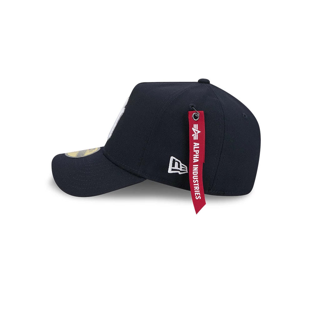 New York Yankees MLB X Alpha Navy New Era 59FORTY A-Frame Fitted Cap, side view showing the white New Era flag logo on the left side of the structured navy crown, with a red Alpha Industries tag hanging from the top button.