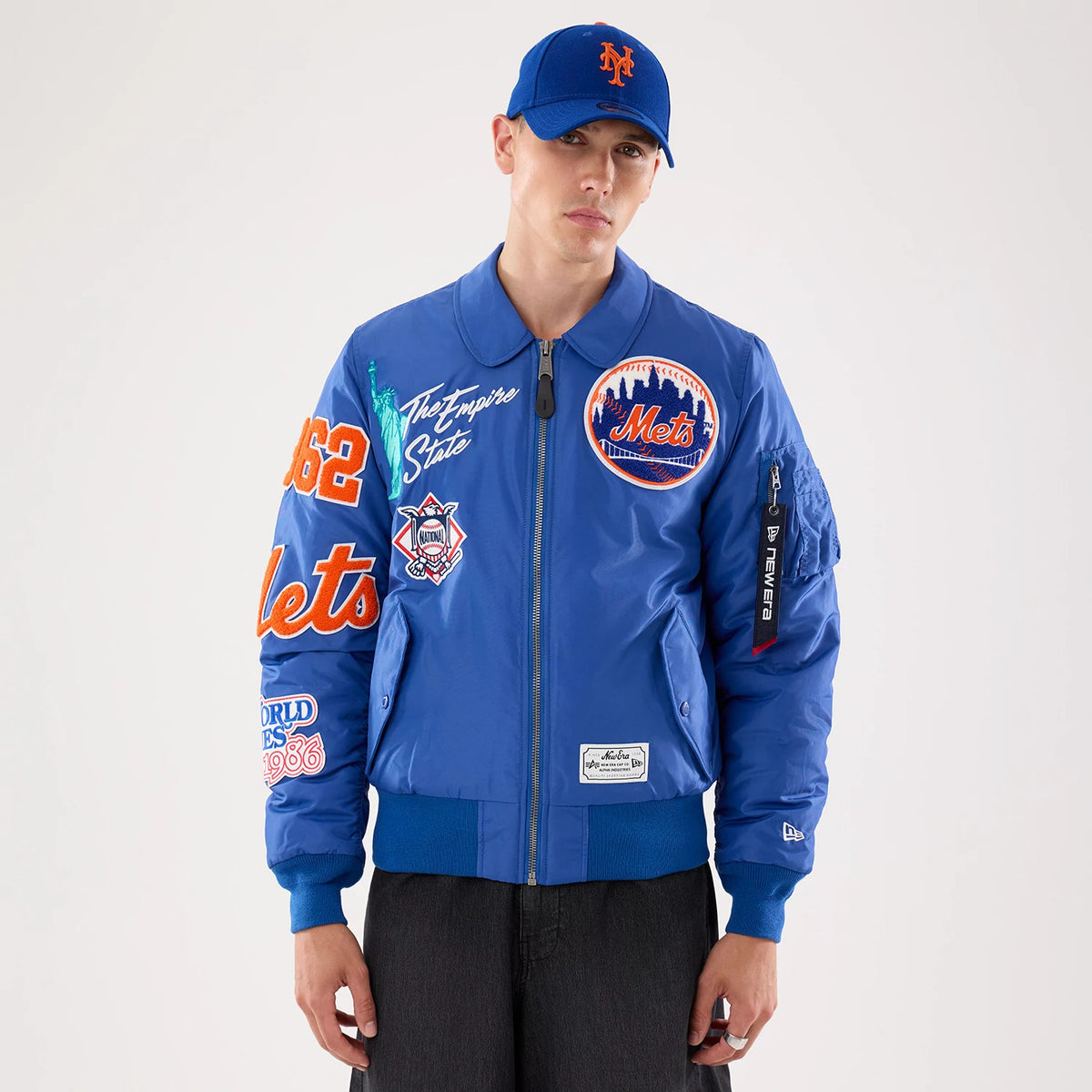 The model is wearing this MLB X Alpha New York Mets Jacket in Blue. 1