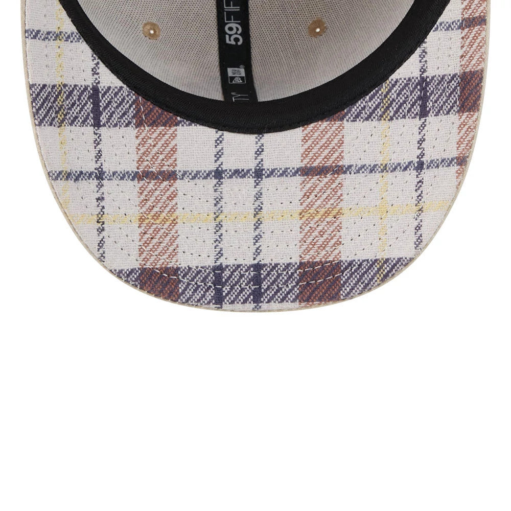 New York Yankees MLB Halloween Beige New Era 59FIFTY Fitted Cap, inside view showing a checked pattern on the visor in beige, brown, and navy tones, black inner sweatband, and black 59FIFTY taping with New Era branding alongside ivory panels.